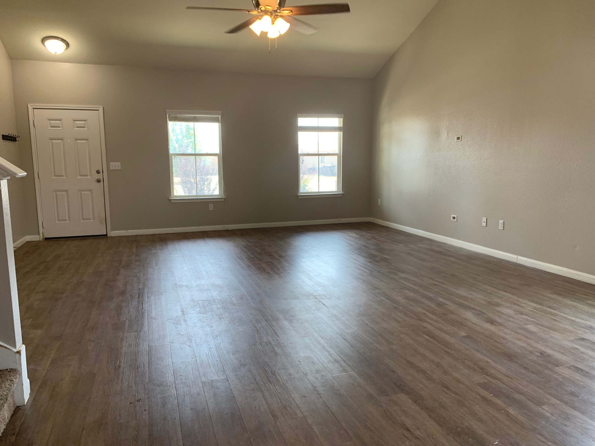 384 Discovery Kyle, TX 78640 - Photo 3 of 18 Unfurnished living room featuring ceiling fan, dark wood-style floors, and lofted ceiling