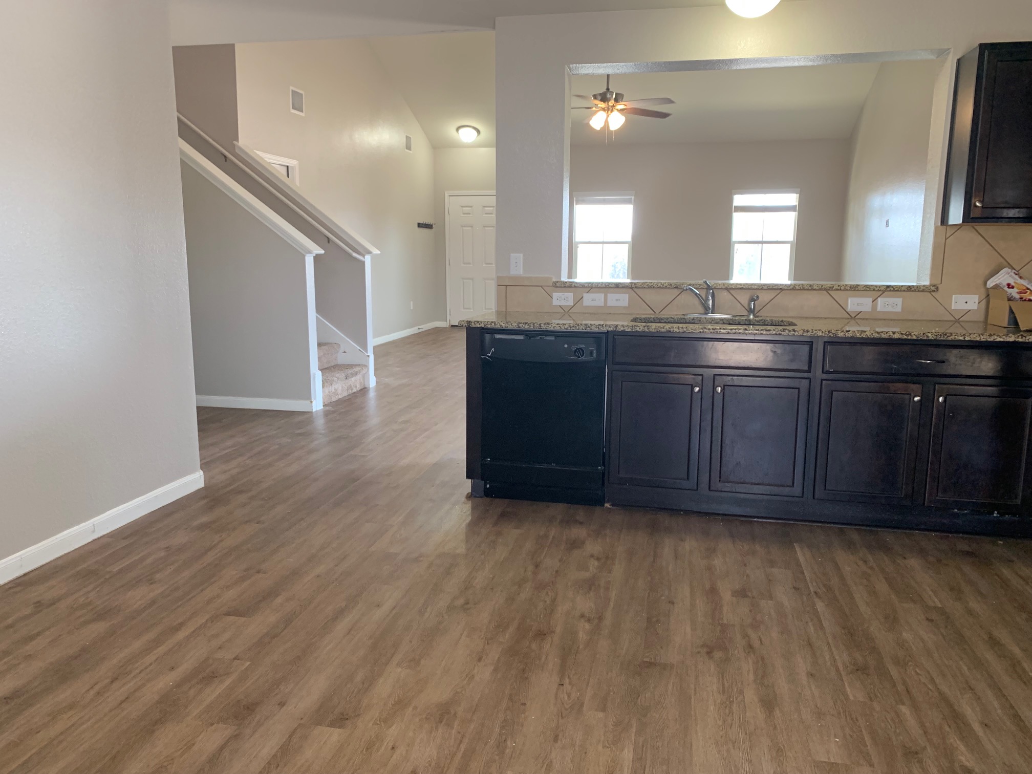384 Discovery Kyle, TX 78640 - Photo 5 of 18 Kitchen featuring dishwasher, ceiling fan, light wood-style flooring, light stone countertops, and decorative backsplash
