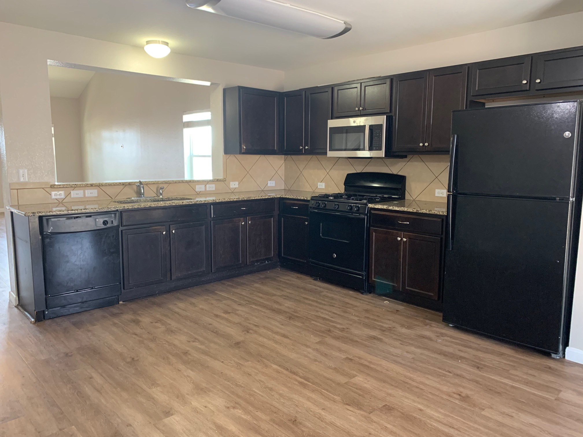 384 Discovery Kyle, TX 78640 - Photo 6 of 18 Kitchen featuring black appliances, tasteful backsplash, and light wood-type flooring