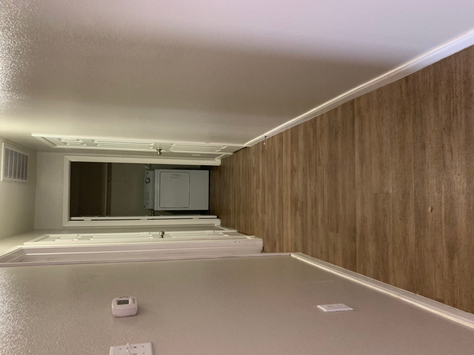 384 Discovery Kyle, TX 78640 - Photo 8 of 18 Corridor featuring washer / dryer, dark wood-style floors, and a textured wall