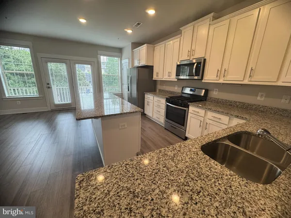 a view of an entryway with wooden floor