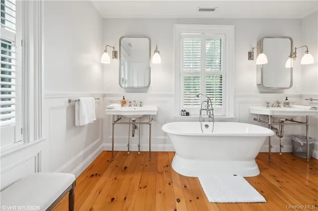 a bathroom with a sink mirror and a bathtub