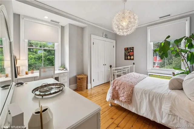 a spacious bedroom with a bed and a table