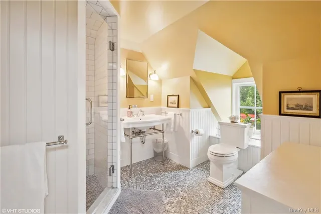 a bathroom with a sink toilet a mirror and shower