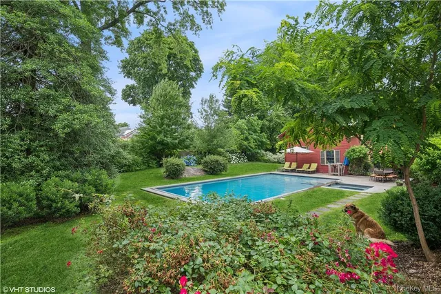a view of a swimming pool with a yard