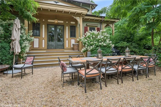 a view of a house with backyard sitting area and garden
