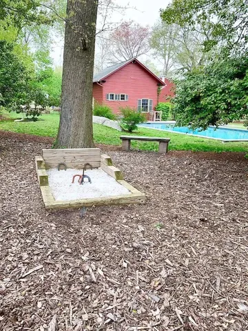 a view of a house with a yard and a tree