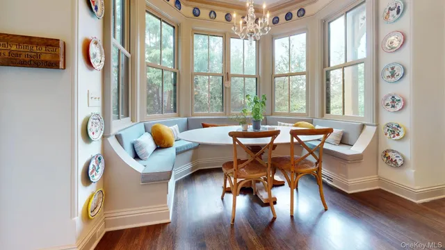 a living room with furniture and floor to ceiling windows