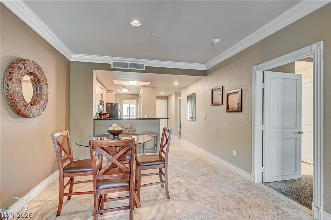230 East Flamingo Road, Unit 333 Las Vegas, NV 89169 - Photo 17 of 61 Crown molding and diagonal tile floors define this open dining area adjacent to the kitchen.