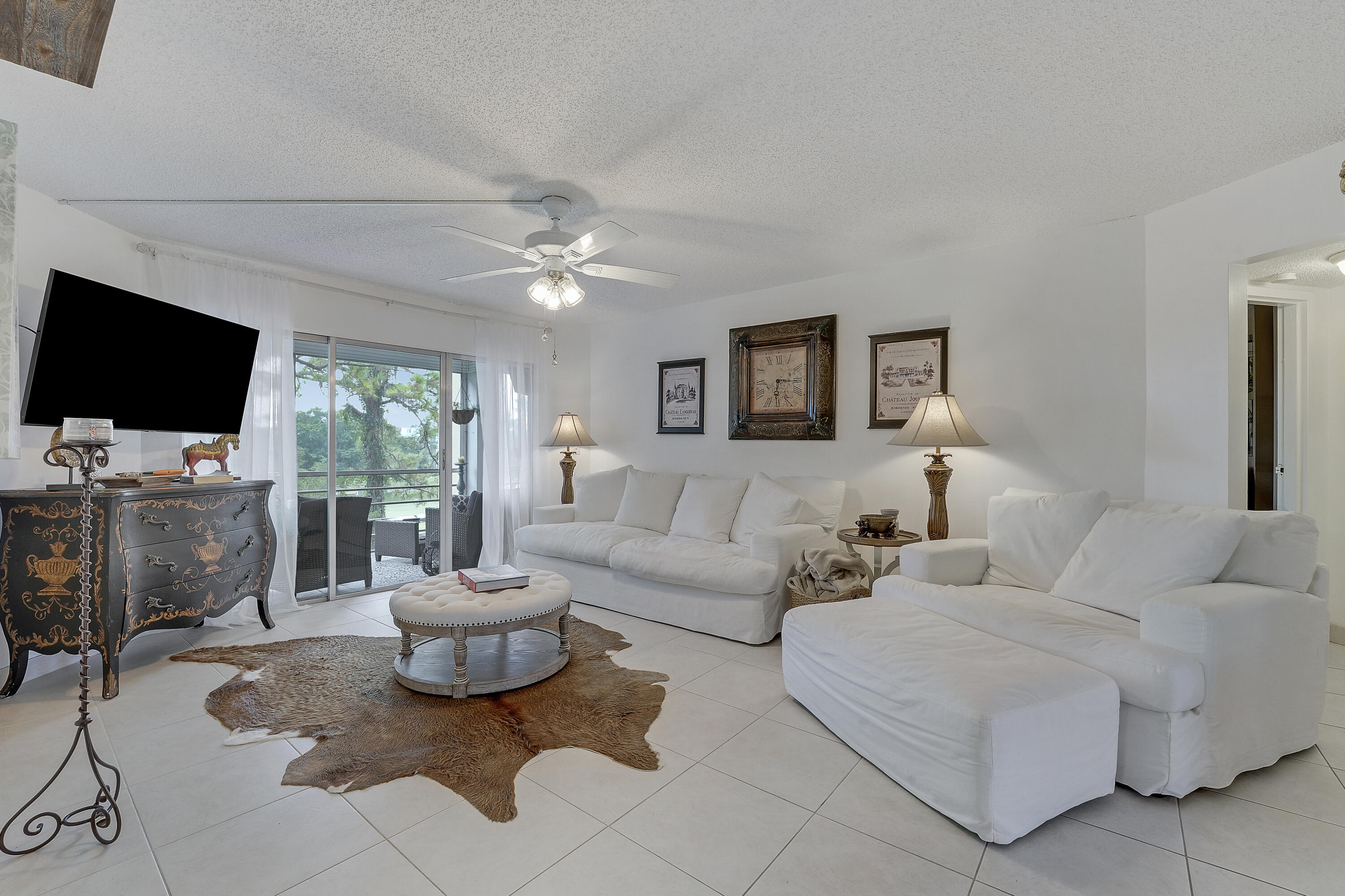 3755 Via Poinciana Lake Worth, FL 33467 - Photo 1 of 20 a living room with furniture a flat screen tv and a window