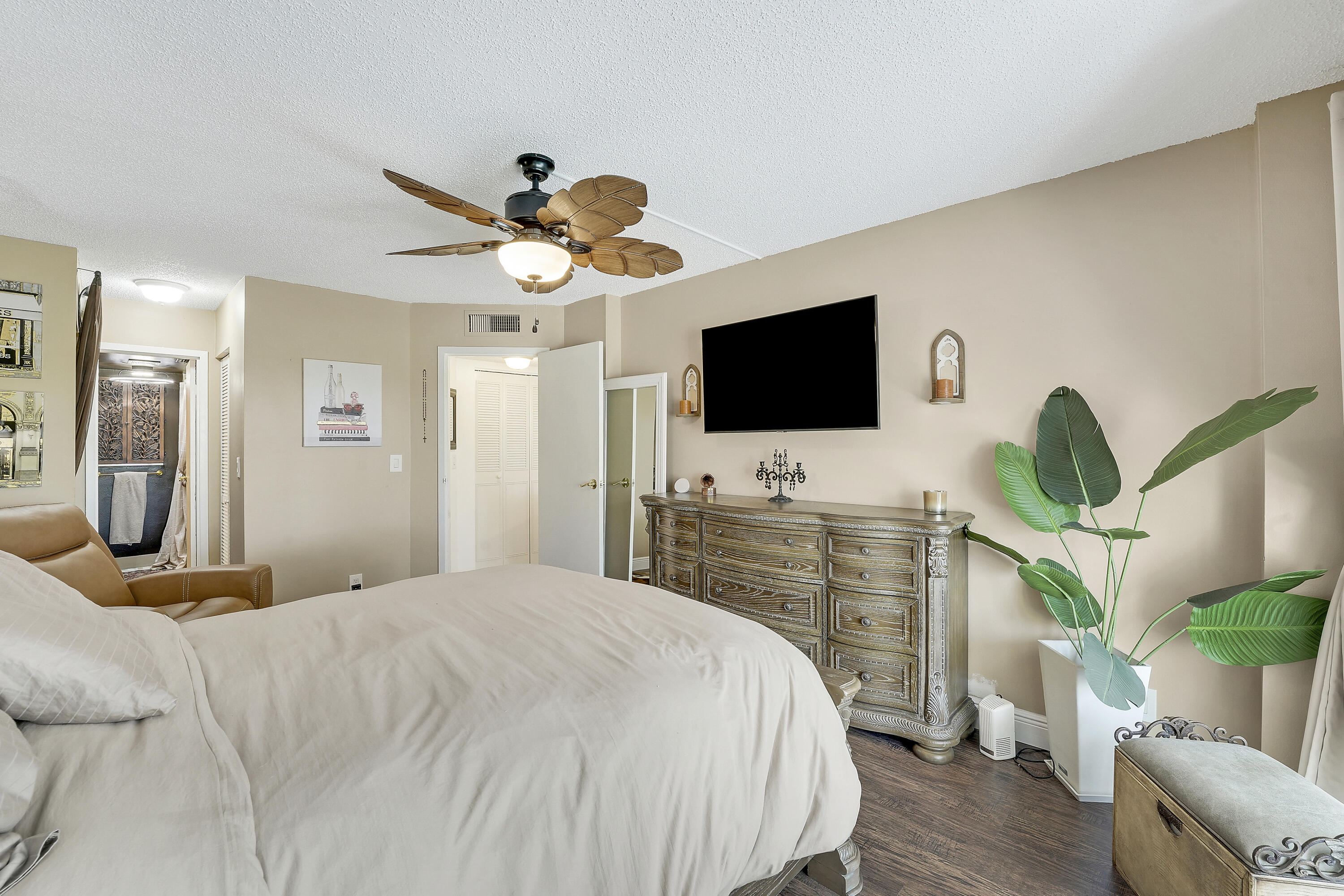 3755 Via Poinciana Lake Worth, FL 33467 - Photo 11 of 20 a bedroom with a bed a flat screen tv and a couch