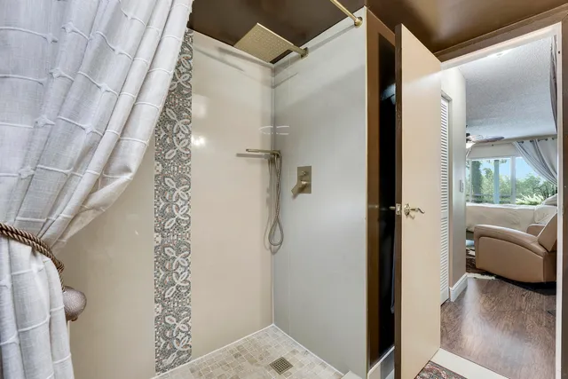 a bathroom with a shower and a sink