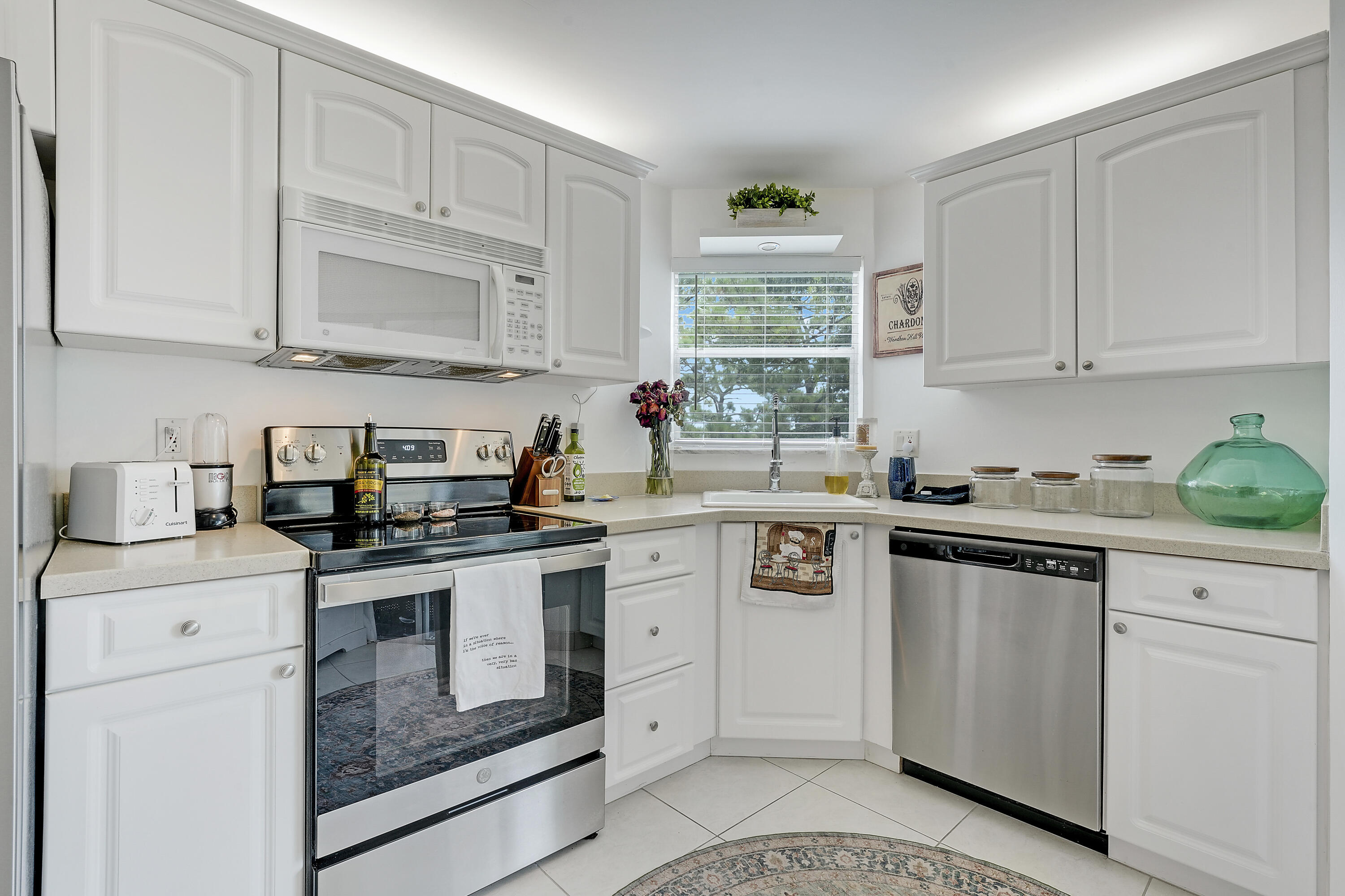 3755 Via Poinciana Lake Worth, FL 33467 - Photo 7 of 20 a kitchen with white cabinets and white appliances
