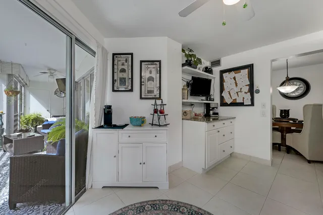 a kitchen with stainless steel appliances kitchen island granite countertop a refrigerator and a sink