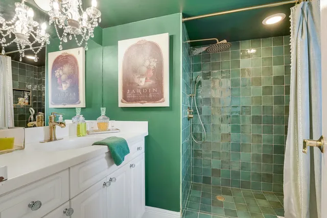 a bathroom with a sink mirror and shower