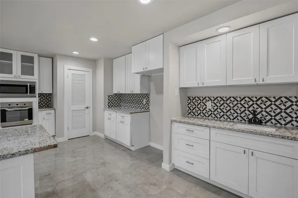a view of a kitchen with a sink and cabinets