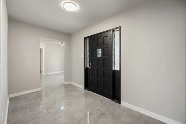 an empty room with closet and a bathroom