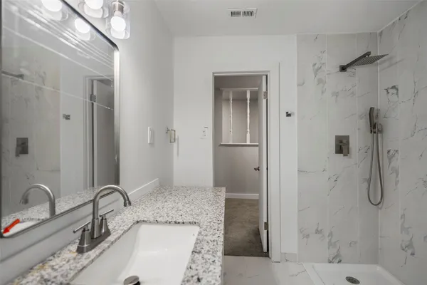 an empty room with windows and ceiling fan view