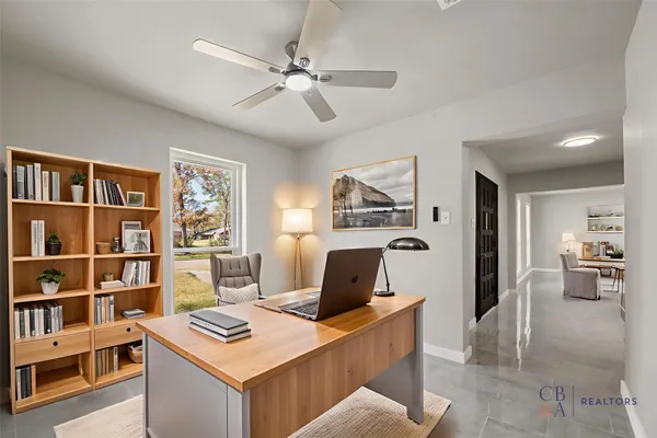 a workspace with furniture and book shelf