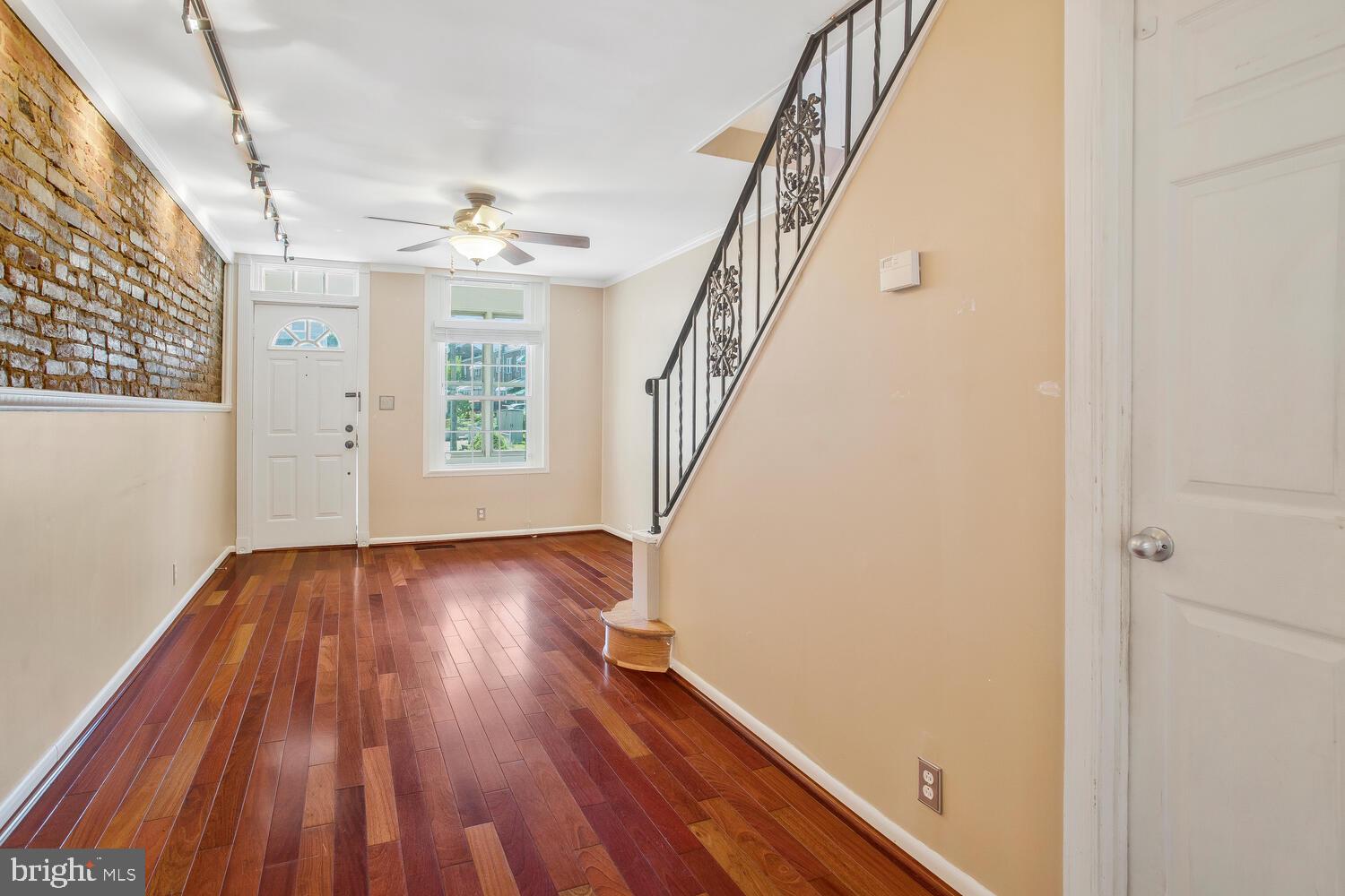 1148 Roland Heights Avenue Baltimore, MD 21211 - Photo 3 of 38 Newer hardwood in main level with exposed brick