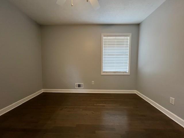 6935 Fielder Road Rex, GA 30273 - Photo 14 of 22 an empty room with wooden floor and windows