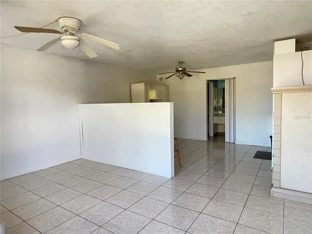 a view of a room with a cabinets and wooden floor