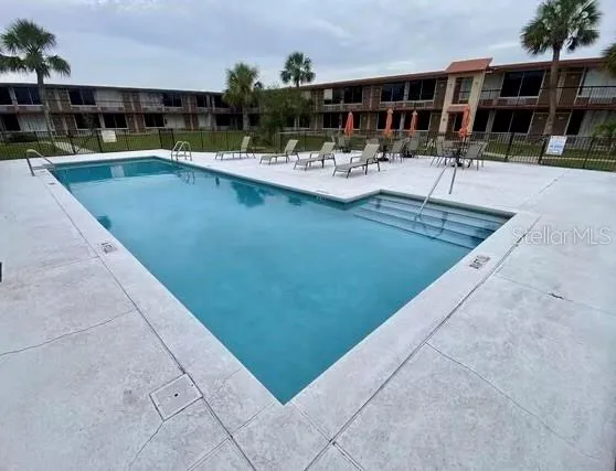a view of swimming pool with outdoor seating