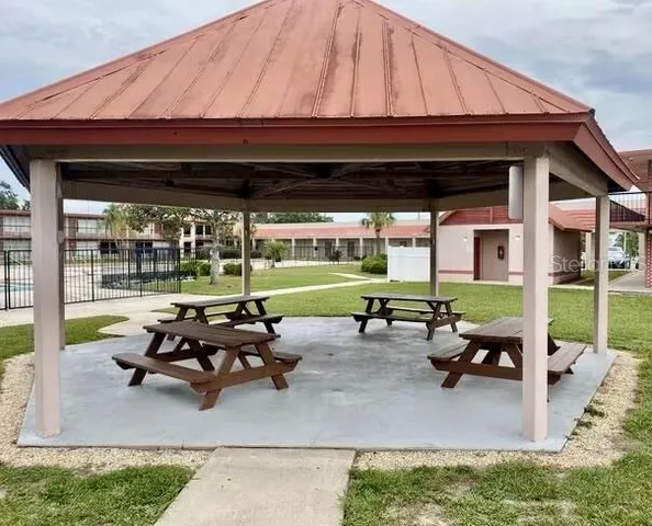 a view of a patio with table and chairs under an umbrella