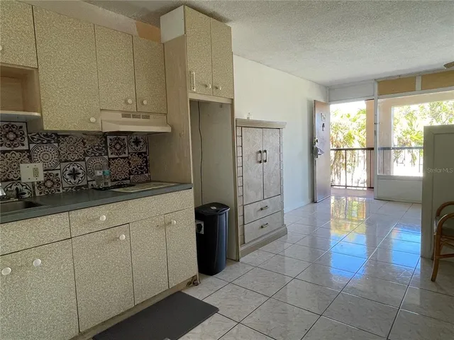 a kitchen with stainless steel appliances a refrigerator sink and cabinets