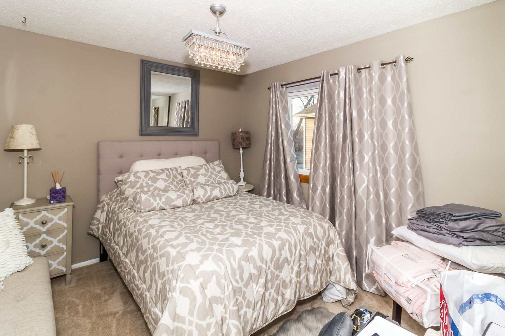 33 Oakview Road Matteson, IL 60443 - Photo 16 of 31 a bedroom with a bed and a chandelier