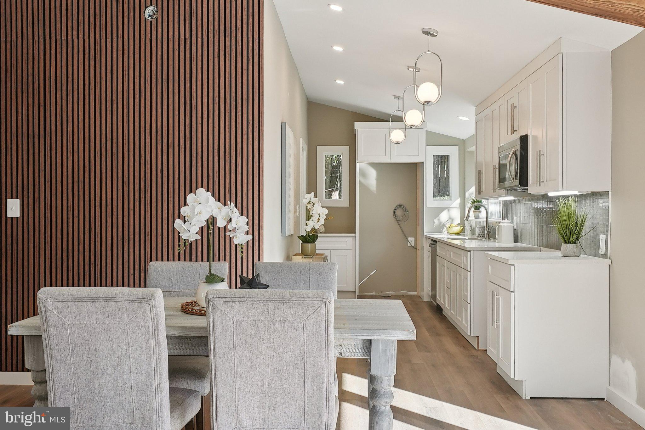 11511 Highview Avenue Silver Spring, MD 20902 - Photo 11 of 39 a kitchen with stainless steel appliances kitchen island granite countertop furniture and a chandelier