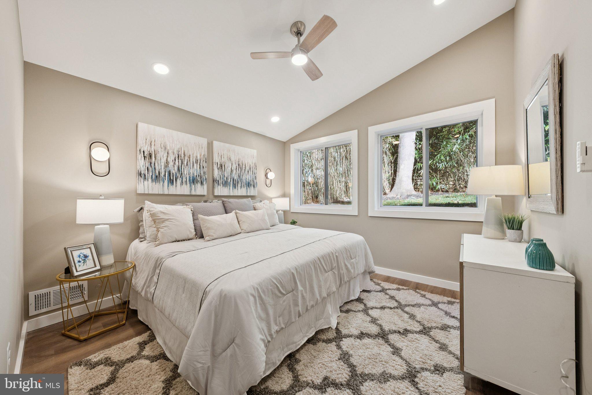 11511 Highview Avenue Silver Spring, MD 20902 - Photo 23 of 39 a bedroom with a large bed and a chandelier