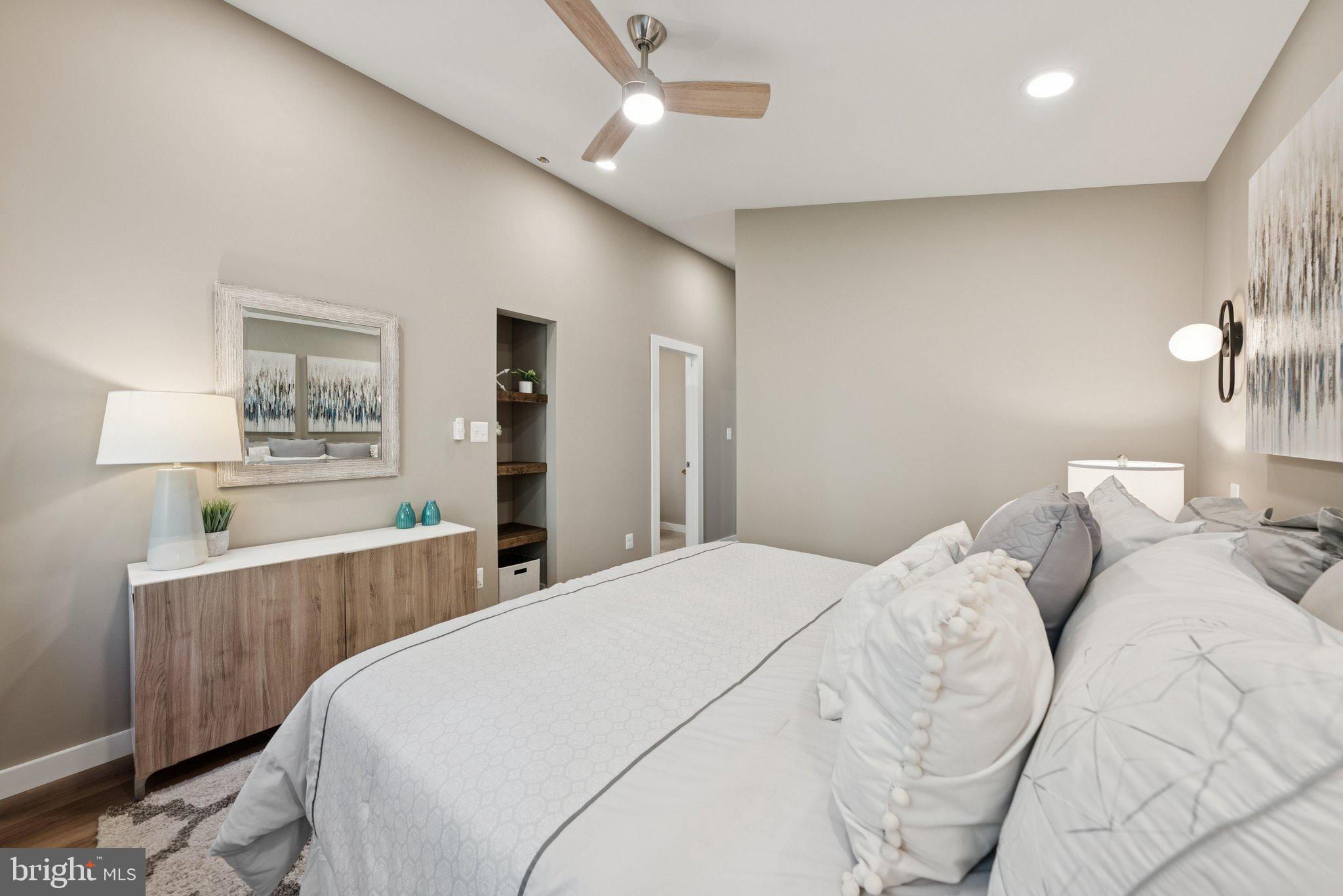 11511 Highview Avenue Silver Spring, MD 20902 - Photo 25 of 39 a bedroom with a white bed and a chandelier