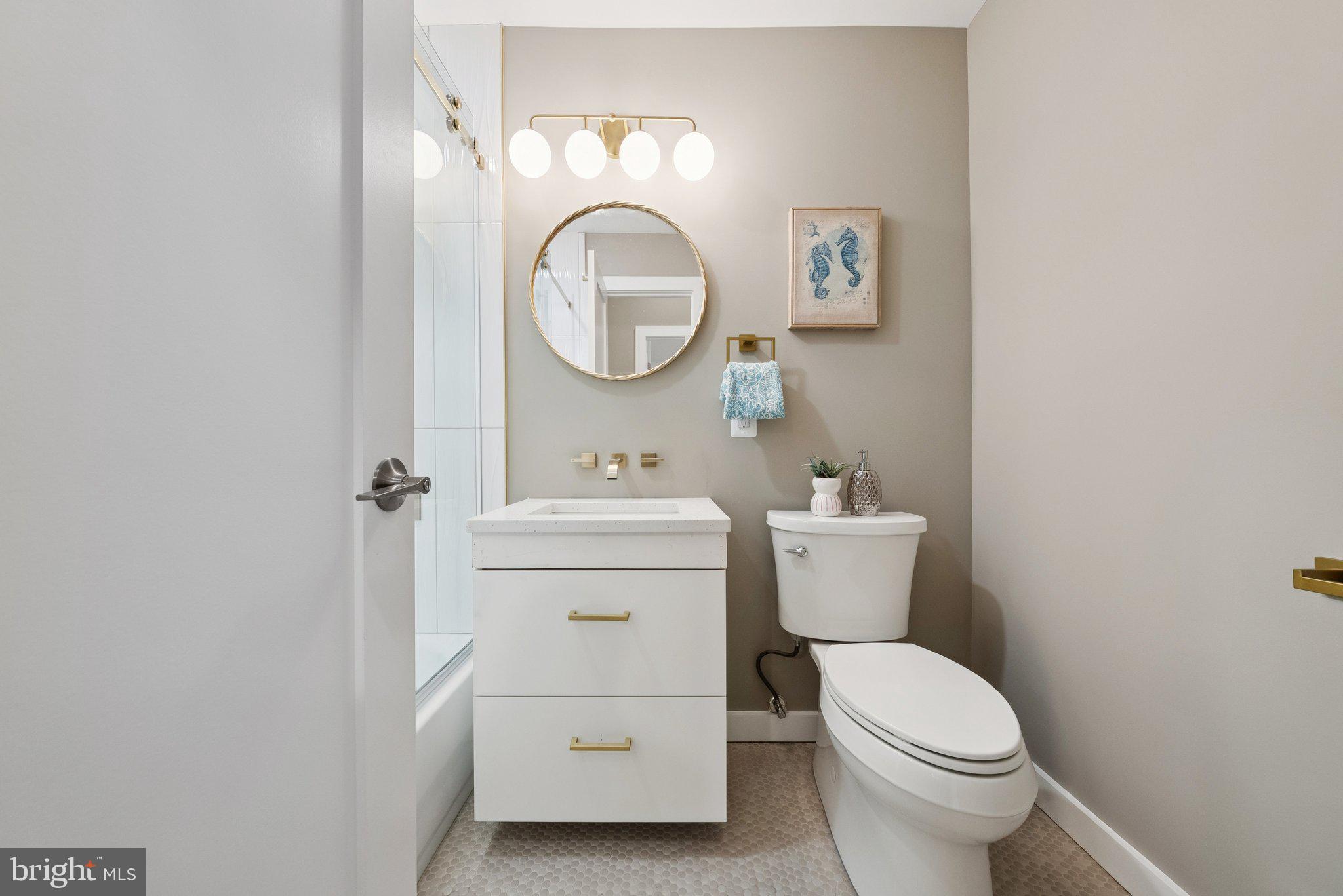 11511 Highview Avenue Silver Spring, MD 20902 - Photo 28 of 39 a bathroom with a toilet sink vanity and mirror