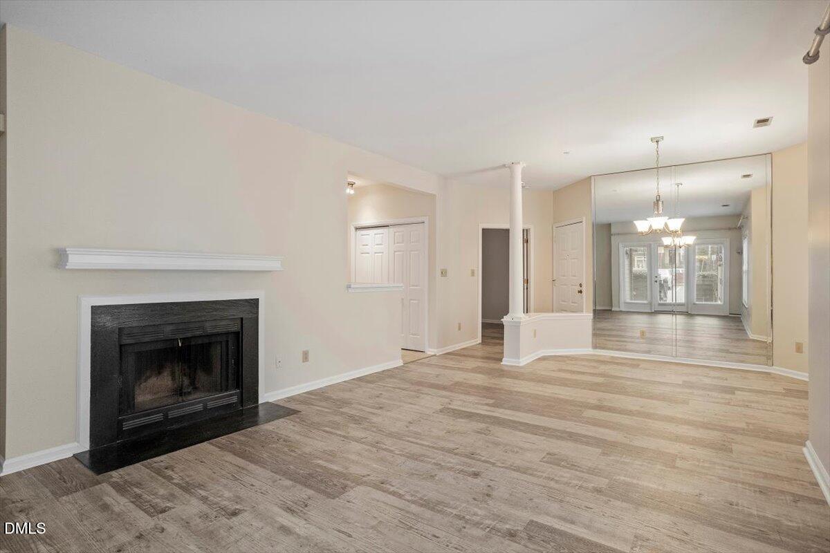 1001 Brighthurst Drive, Unit 106 Raleigh, NC 27605 - Photo 11 of 23 a view of empty room with wooden floor and fireplace