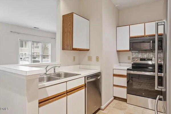 a kitchen that has a sink and a stove top oven