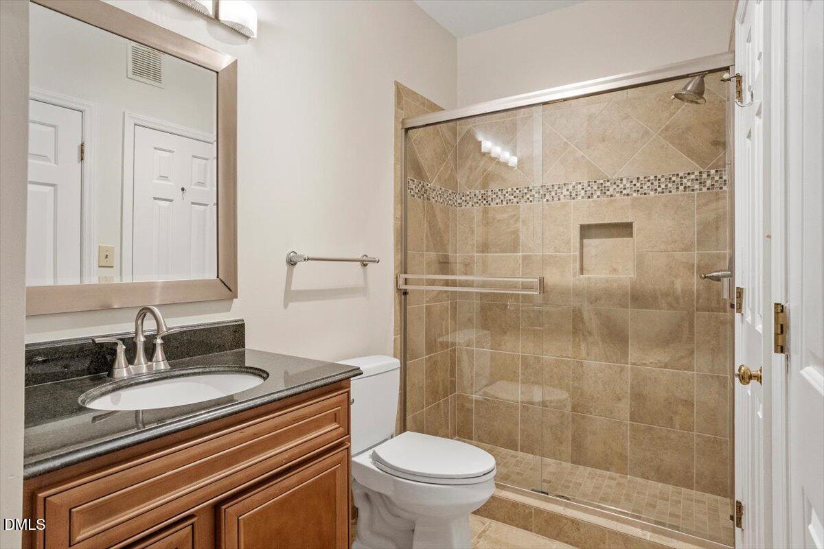 1001 Brighthurst Drive, Unit 106 Raleigh, NC 27605 - Photo 21 of 23 a bathroom with a sink toilet and shower