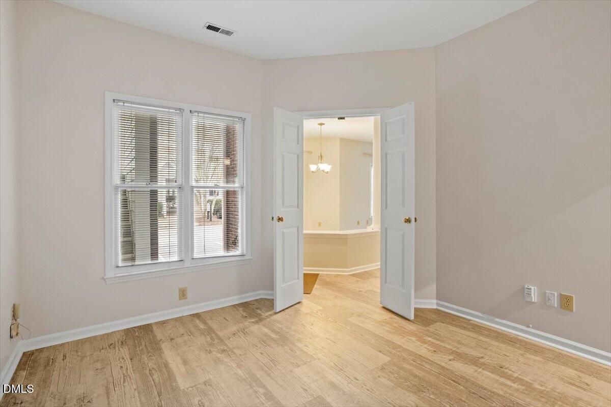 1001 Brighthurst Drive, Unit 106 Raleigh, NC 27605 - Photo 23 of 23 an empty room with wooden floor and windows