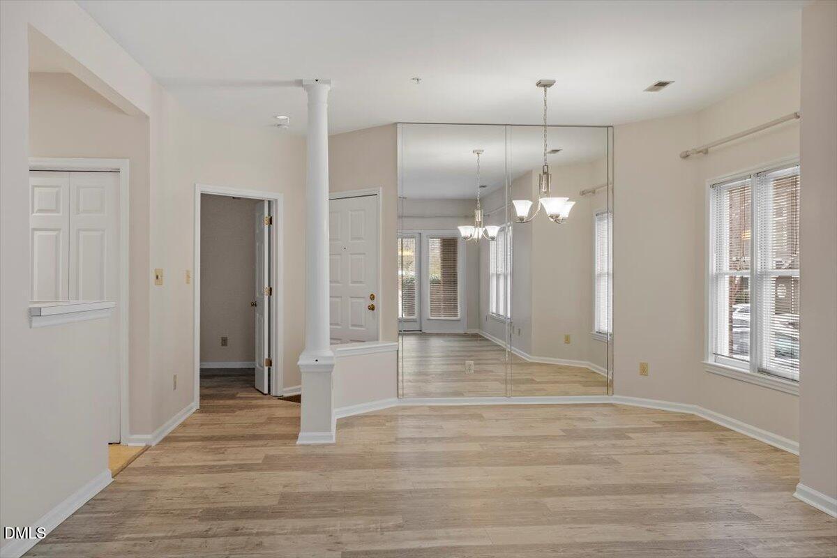 1001 Brighthurst Drive, Unit 106 Raleigh, NC 27605 - Photo 7 of 23 a view of a hallway with wooden floor and a bathroom