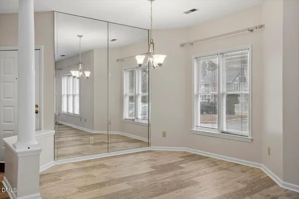 a view of a room with an empty space and wooden floor