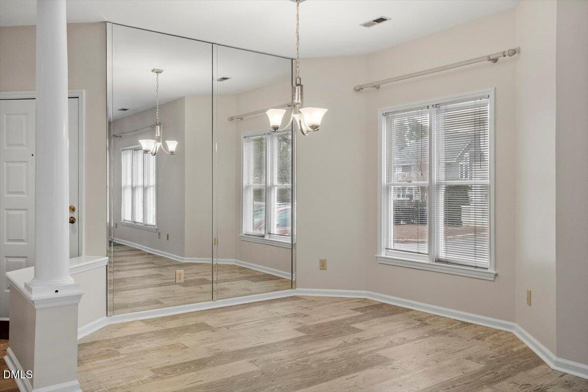 1001 Brighthurst Drive, Unit 106 Raleigh, NC 27605 - Photo 8 of 23 a view of a room with an empty space and wooden floor