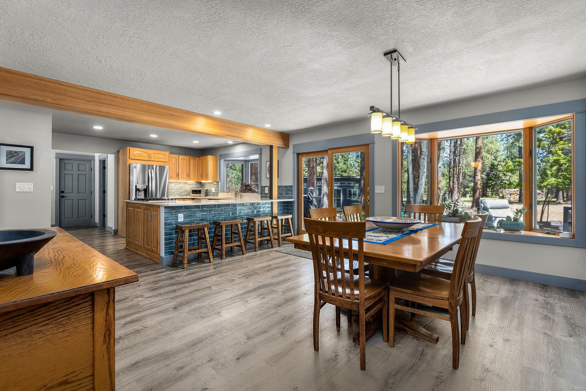 60210 East Ridgeview Drive Bend, OR 97702 - Photo 9 of 55 a dining room with furniture window wooden floor