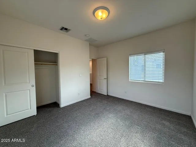 an empty room with closet area