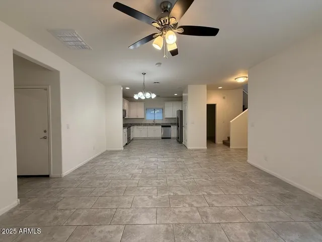 a view of an empty room with a kitchen
