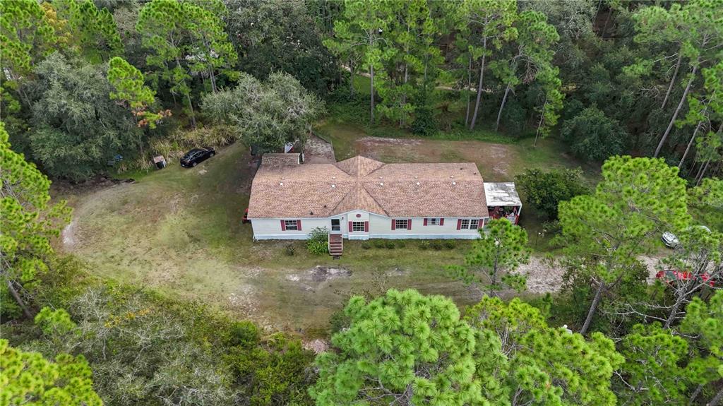 6701 Nova Road St. Cloud, FL 34771 - Photo 1 of 49 an aerial view of a house with a yard and a large tree