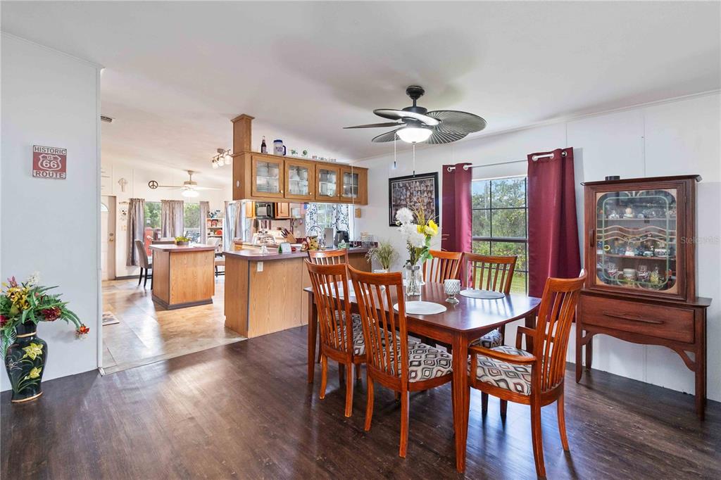 6701 Nova Road St. Cloud, FL 34771 - Photo 15 of 49 a view of a dining room with furniture window and wooden floor