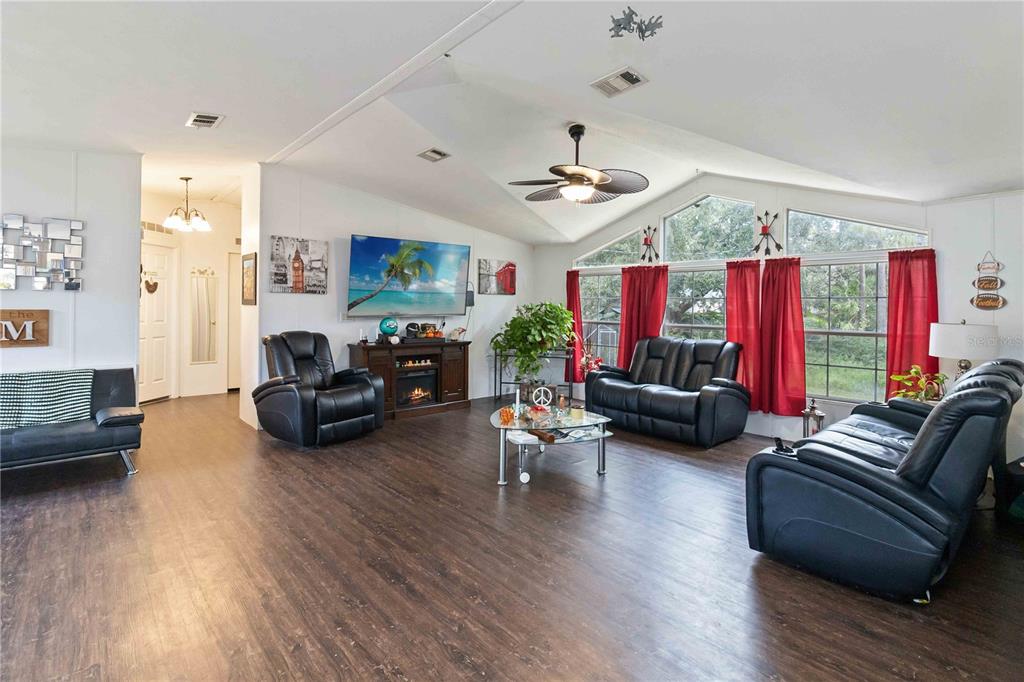 6701 Nova Road St. Cloud, FL 34771 - Photo 18 of 49 a living room with furniture kitchen view and a wooden floor