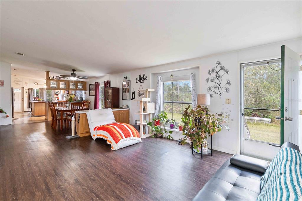 6701 Nova Road St. Cloud, FL 34771 - Photo 23 of 49 a living room with furniture and a floor to ceiling window