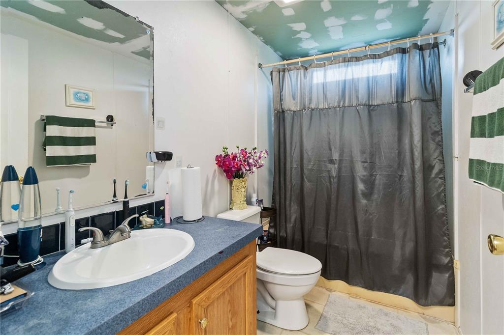 6701 Nova Road St. Cloud, FL 34771 - Photo 31 of 49 a bathroom with a toilet a sink and a mirror