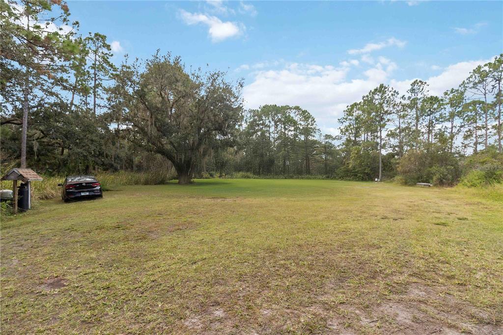 6701 Nova Road St. Cloud, FL 34771 - Photo 36 of 49 a view of outdoor space with deck and yard